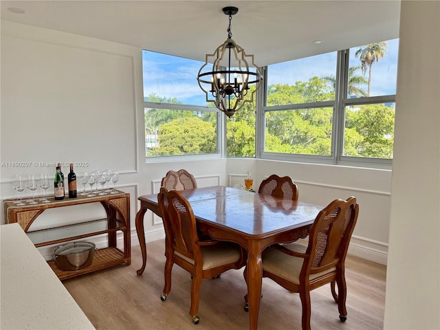 16546 NE 26th Ave Unit 3G, North Miami Beach, FL 33160 - dining area featuring a chandelier and light wood-style flooring