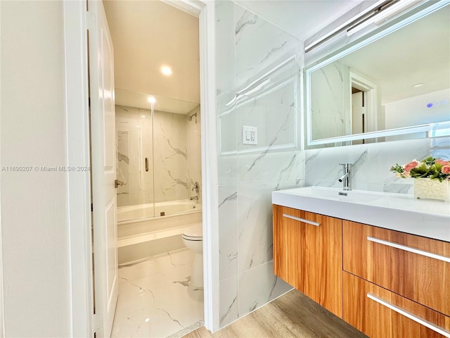 full bathroom with toilet, hardwood / wood-style floors, vanity, and shower / bath combination