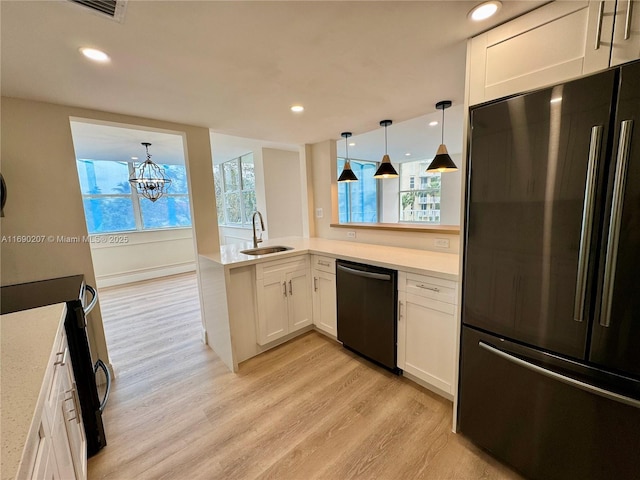 16546 NE 26th Ave Unit 3G, North Miami Beach, FL 33160 - kitchen with freestanding refrigerator, dishwasher, light wood-style flooring, stainless steel electric range oven, and white cabinetry