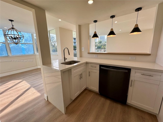 16546 NE 26th Ave Unit 3G, North Miami Beach, FL 33160 - kitchen with dishwasher, wood finished floors, light countertops, a peninsula, and recessed lighting