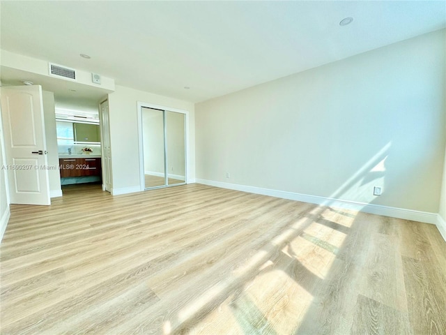 unfurnished bedroom with light wood-type flooring