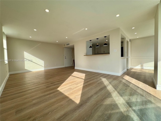 16546 NE 26th Ave Unit 3G, North Miami Beach, FL 33160 - unfurnished living room featuring wood finished floors and recessed lighting