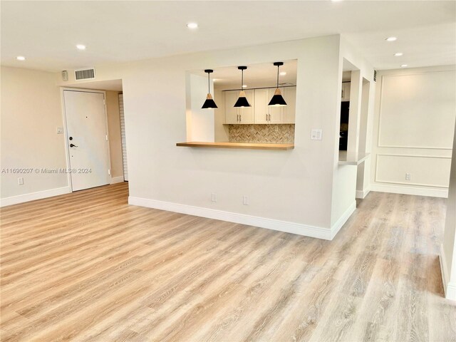 unfurnished living room featuring light hardwood / wood-style floors