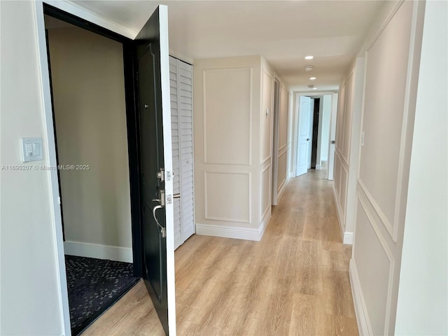 16546 NE 26th Ave Unit 3G, North Miami Beach, FL 33160 - hall with a decorative wall and light wood-style floors