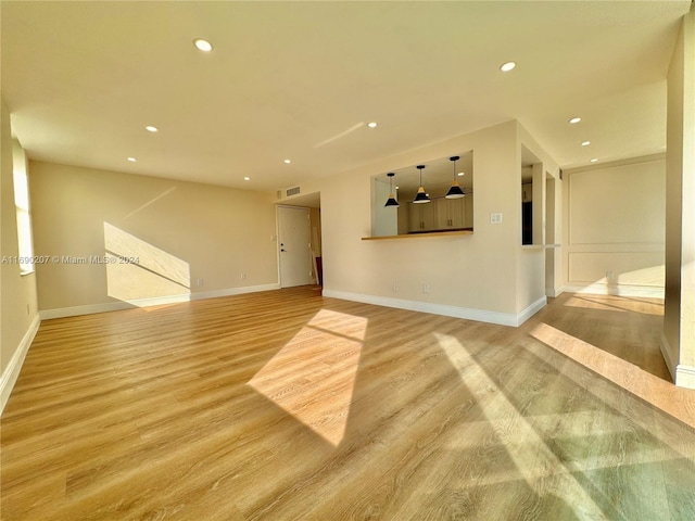 unfurnished living room with light hardwood / wood-style floors