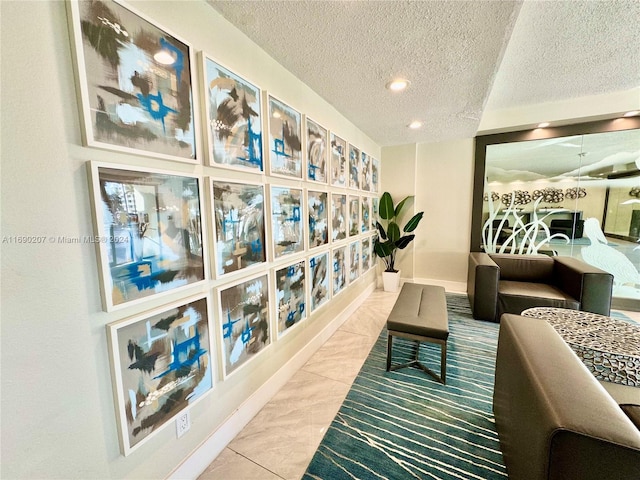 sitting room featuring a textured ceiling and tile patterned floors