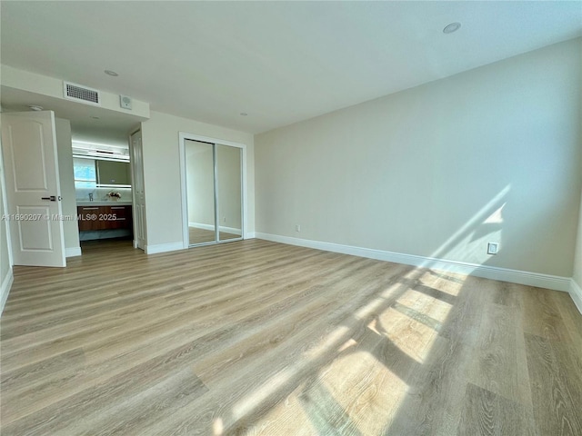 16546 NE 26th Ave Unit 3G, North Miami Beach, FL 33160 - unfurnished bedroom featuring light wood-type flooring and a closet