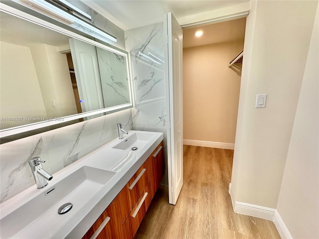 16546 NE 26th Ave Unit 3G, North Miami Beach, FL 33160 - bathroom with decorative backsplash, wood finished floors, and double vanity