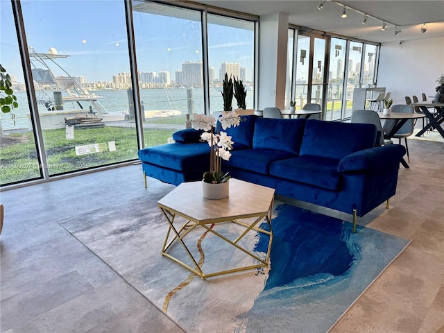 16546 NE 26th Ave Unit 3G, North Miami Beach, FL 33160 - living room with plenty of natural light, finished concrete flooring, and track lighting