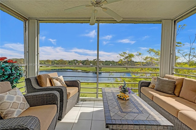 sunroom / solarium with a water view, ceiling fan, and plenty of natural light