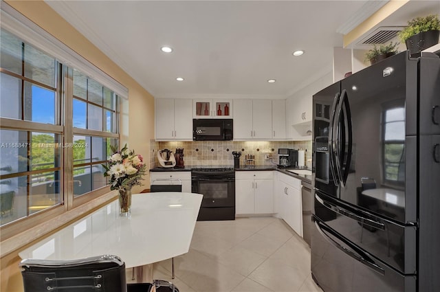 kitchen featuring black appliances, light tile patterned flooring, crown molding, decorative backsplash, and white cabinets