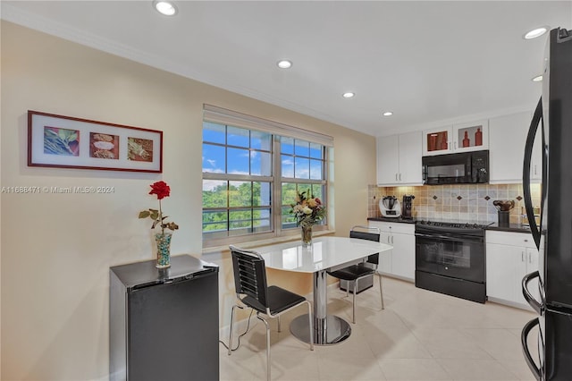 kitchen featuring black appliances, ornamental molding, light tile patterned floors, white cabinets, and decorative backsplash