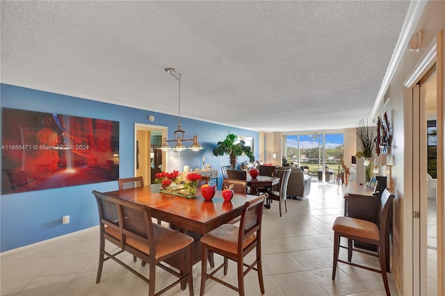 tiled dining area featuring ornamental molding, a wall of windows, and a textured ceiling