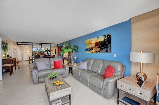 tiled living room featuring a textured ceiling