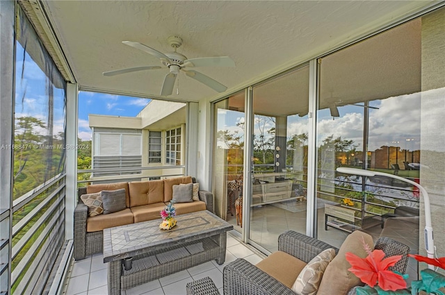 sunroom / solarium featuring ceiling fan