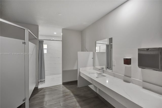 bathroom featuring vanity, hardwood / wood-style flooring, and a shower with door