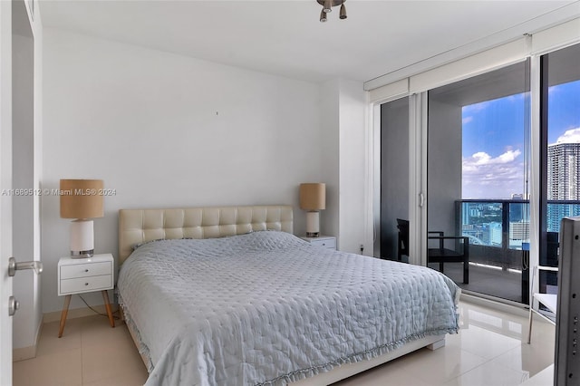 bedroom with access to outside and light tile patterned flooring