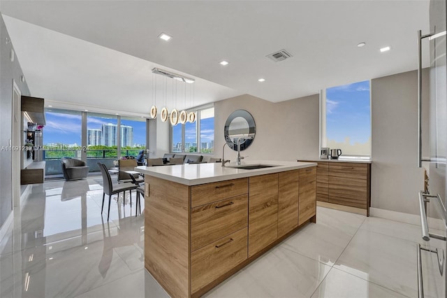 16385 NE Biscayne Blvd Unit 307 2Parking, North Miami Beach, FL 33160 - kitchen featuring modern cabinets, a sink, brown cabinets, light countertops, and healthy amount of natural light