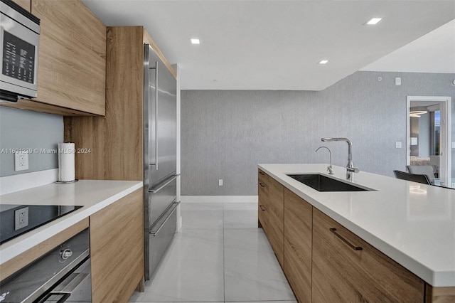 16385 NE Biscayne Blvd Unit 307 2Parking, North Miami Beach, FL 33160 - kitchen with a sink, appliances with stainless steel finishes, modern cabinets, light countertops, and brown cabinets