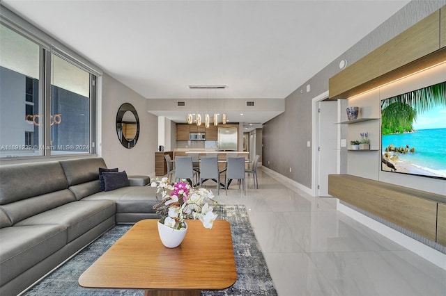 16385 NE Biscayne Blvd Unit 307 2Parking, North Miami Beach, FL 33160 - living area featuring light marble finish flooring, baseboards, and a chandelier