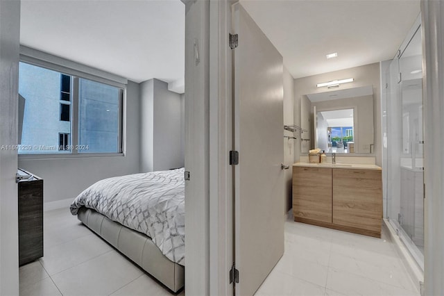 16385 NE Biscayne Blvd Unit 307 2Parking, North Miami Beach, FL 33160 - bedroom featuring a sink, baseboards, and light tile patterned floors