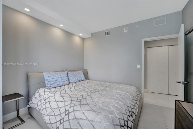 bedroom with light tile patterned floors