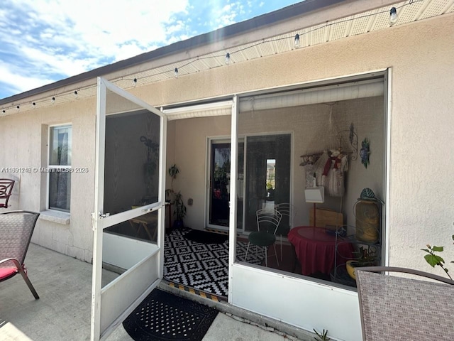 property entrance featuring a patio area