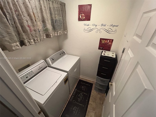 washroom with tile patterned flooring and washer and dryer