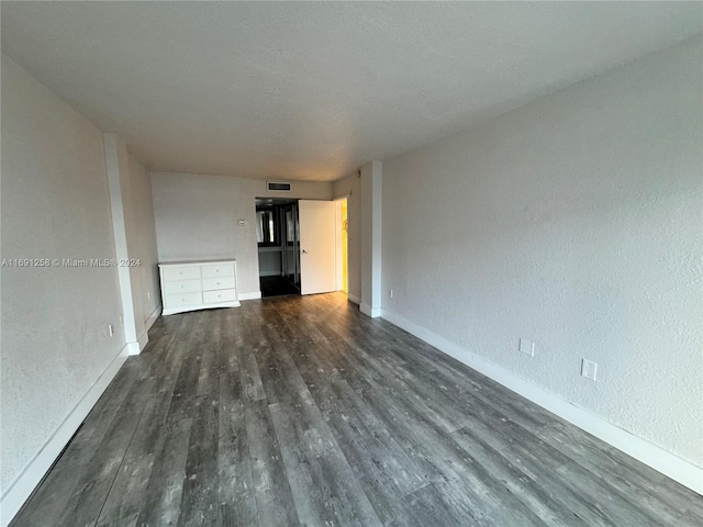 unfurnished living room featuring dark hardwood / wood-style floors