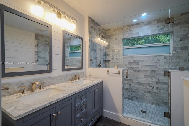 bathroom featuring vanity, hardwood / wood-style flooring, walk in shower, and a healthy amount of sunlight