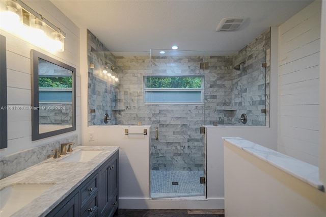 bathroom featuring vanity, wood-type flooring, and a shower with door