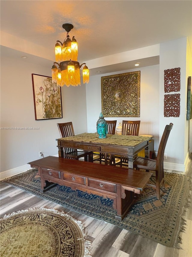 dining room featuring hardwood / wood-style floors and a notable chandelier