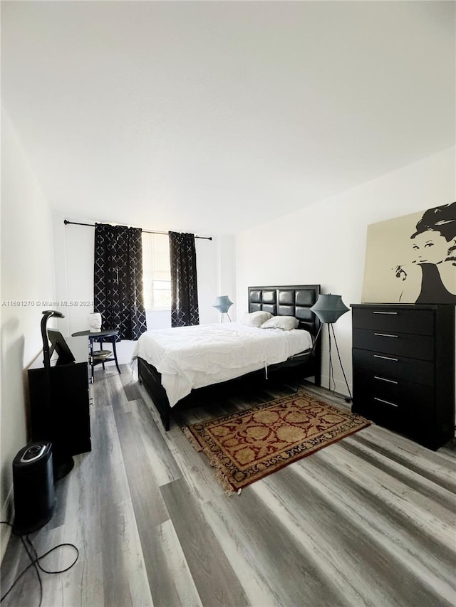 bedroom with hardwood / wood-style floors