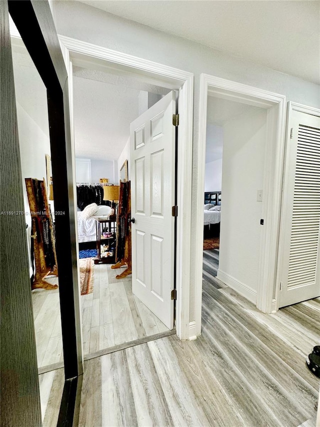 corridor with hardwood / wood-style floors