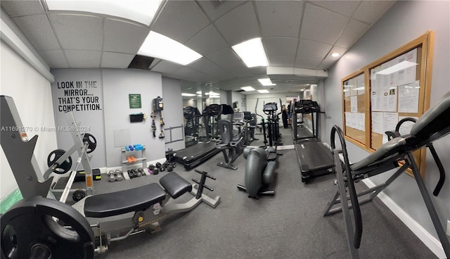 gym with a paneled ceiling