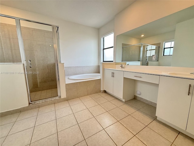 full bath with double vanity, a bath, a shower stall, a sink, and tile patterned floors