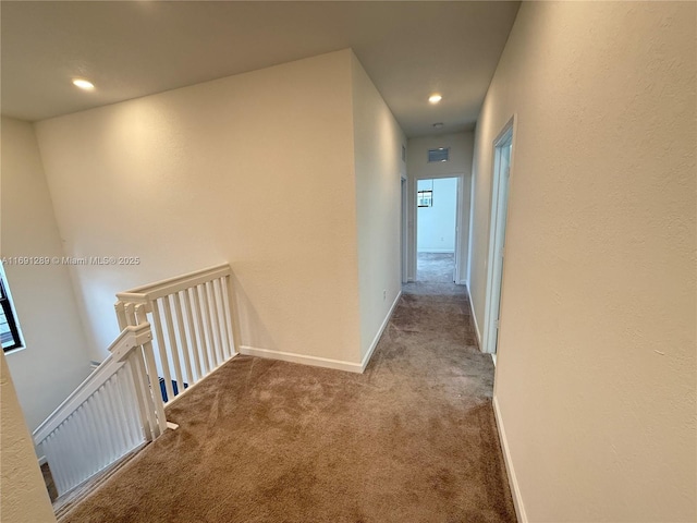 hall with baseboards, carpet flooring, recessed lighting, and visible vents