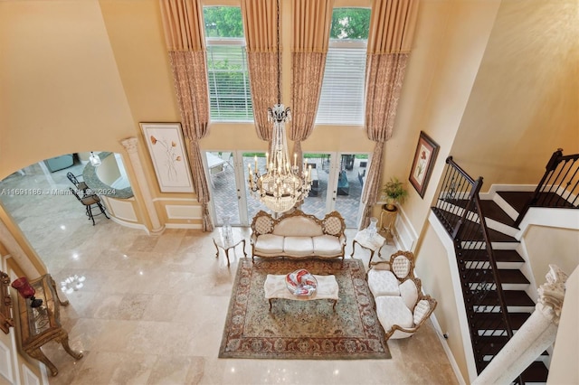 living room with french doors and a high ceiling