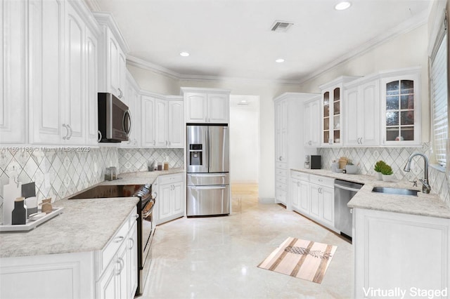 kitchen with sink, ornamental molding, stainless steel appliances, and white cabinets