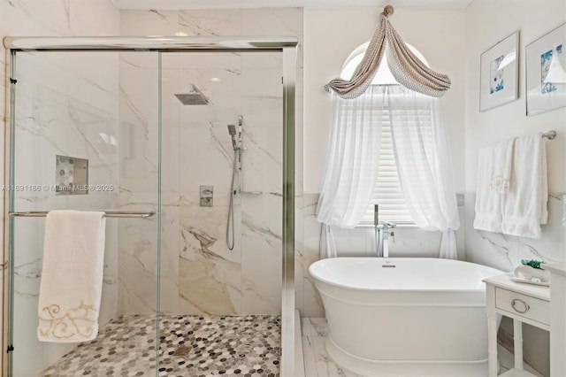 bathroom featuring shower with separate bathtub