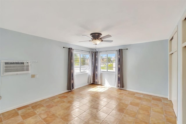 tiled empty room with a wall unit AC and ceiling fan