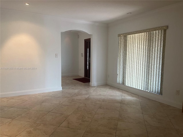 spare room featuring crown molding