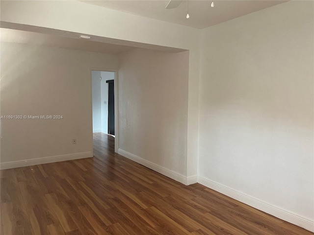 empty room with dark hardwood / wood-style flooring and ceiling fan