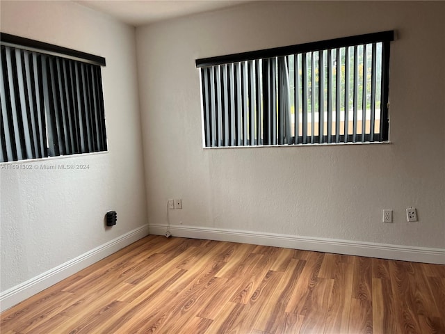 unfurnished room with light hardwood / wood-style floors