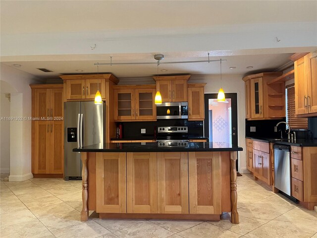 kitchen with stainless steel appliances, light tile patterned floors, decorative light fixtures, backsplash, and a center island