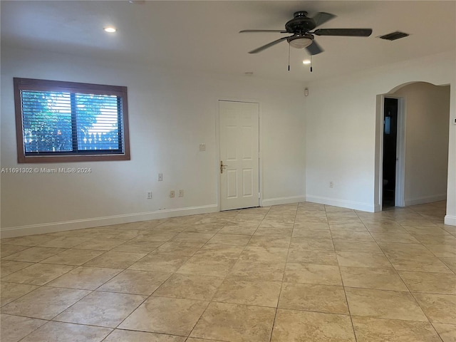 bathroom featuring walk in shower, vanity, toilet, and tile walls