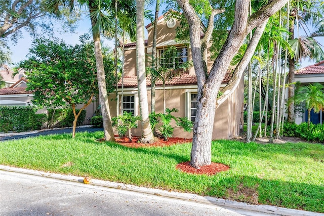 mediterranean / spanish house with a front lawn