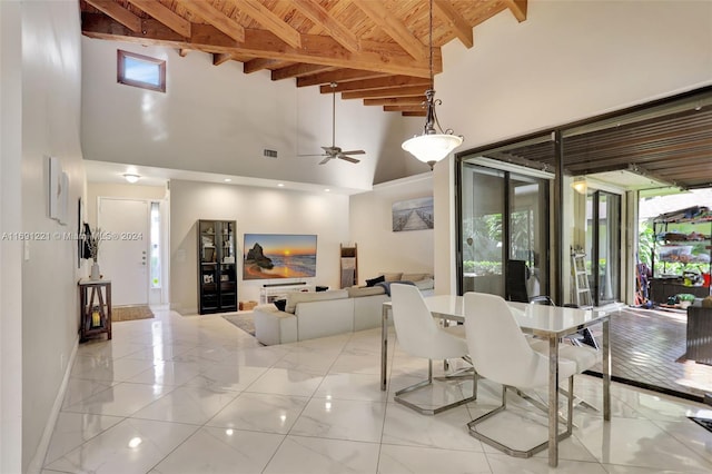 dining space featuring ceiling fan, beam ceiling, light tile patterned floors, and high vaulted ceiling