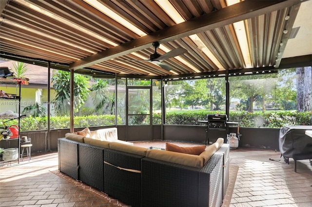 sunroom featuring ceiling fan