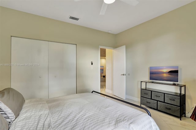 bedroom with ceiling fan and a closet